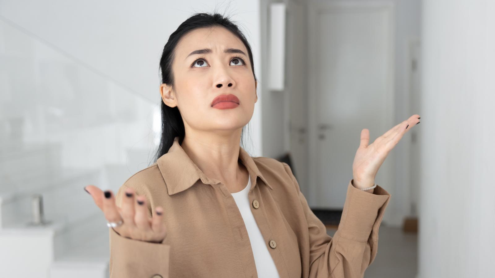 Woman Says Her Neighbor’s Daily Vacuuming Has Turned Into a Constant Source of Frustration woman shrugging her shoulders