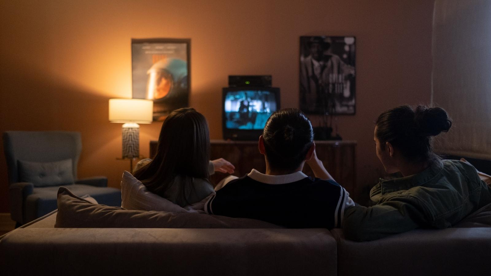 The Boundary Backfire: Why an Emergency Worker Is Being Vilified by Her Friends for Skipping a Horror Movie friends sitting on couch watching movie