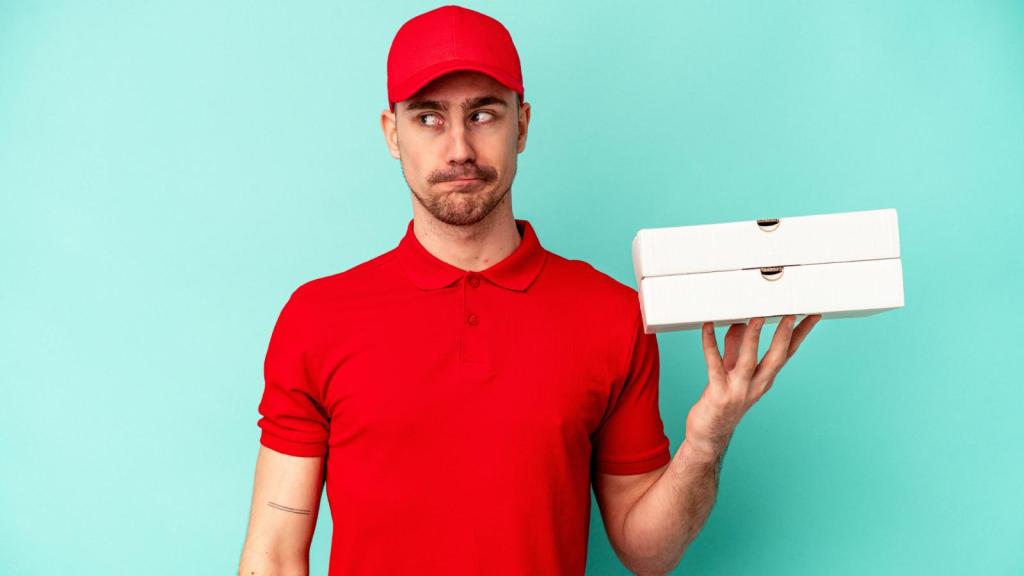 man holding pizza boxes