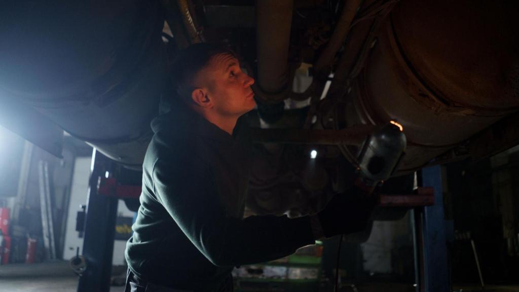 mechanic working under a car