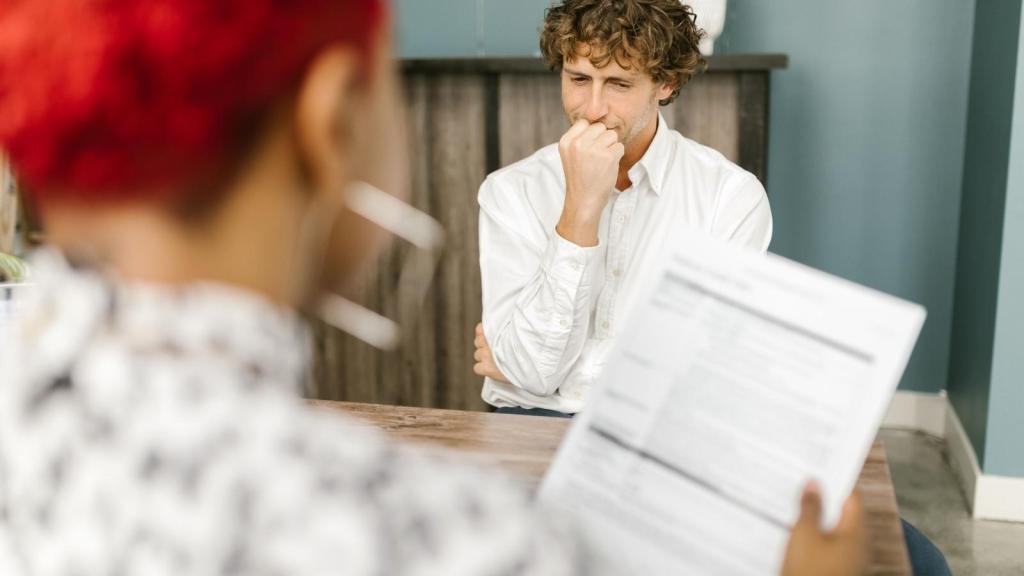 nervous man sitting in a job interview