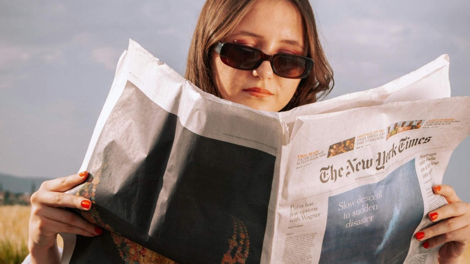 woman reading a newspaper