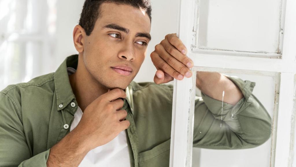 man looking out a window