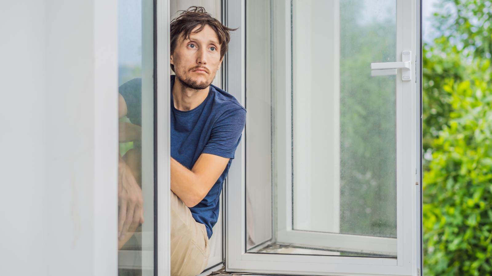 Her Neighbors Blast Music at Night and Wont Stop, So Shes Thinking About Getting Speakers to Get Even man sitting in a window