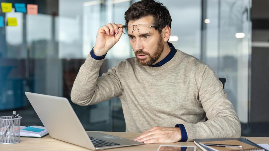 man looking at his computer