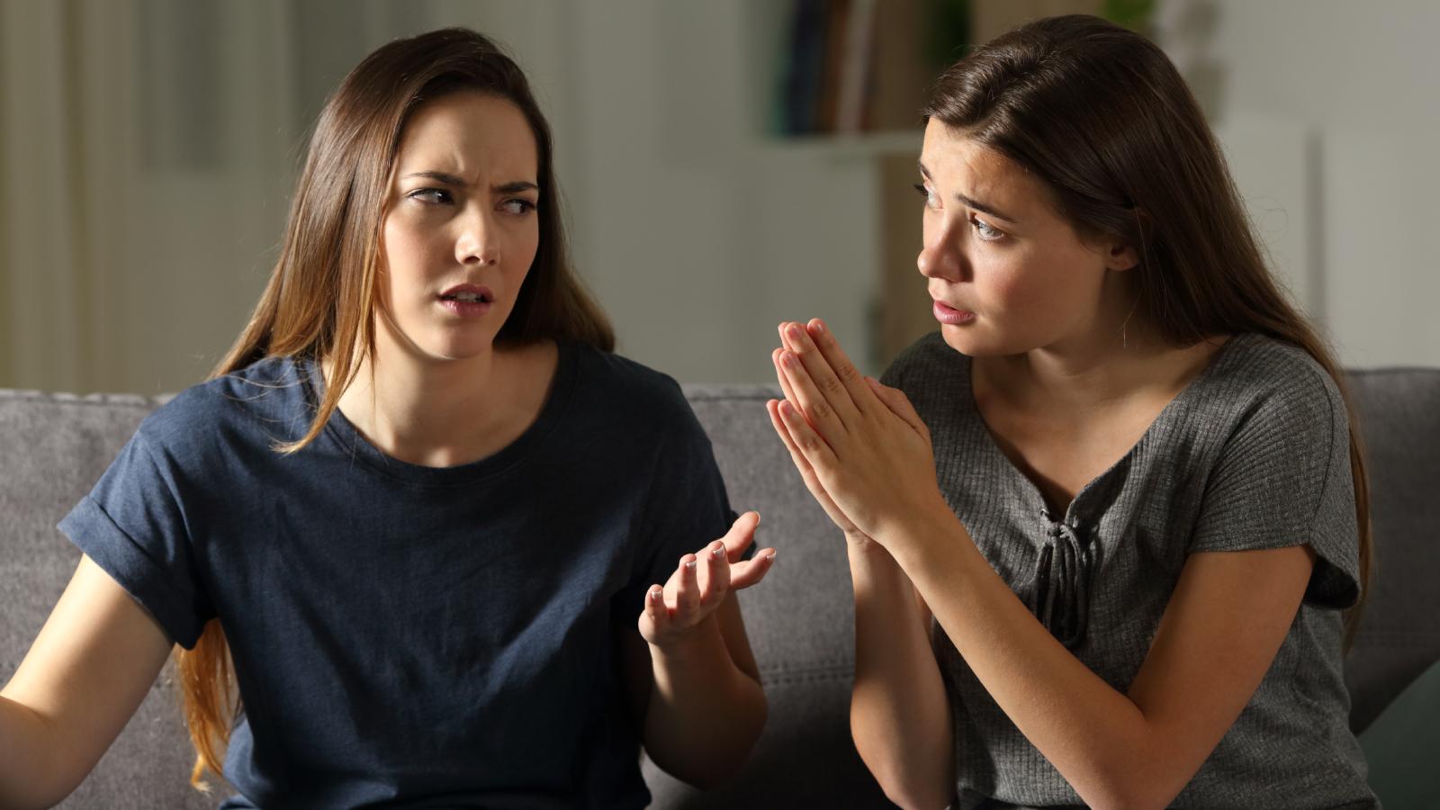 Woman Told Her Roommate Her Boyfriend Is Over Too Much—Now Their Living Situation Is Awkward two women having a conversation