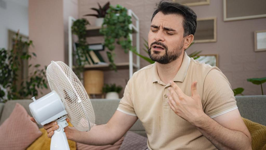 man holding a fan