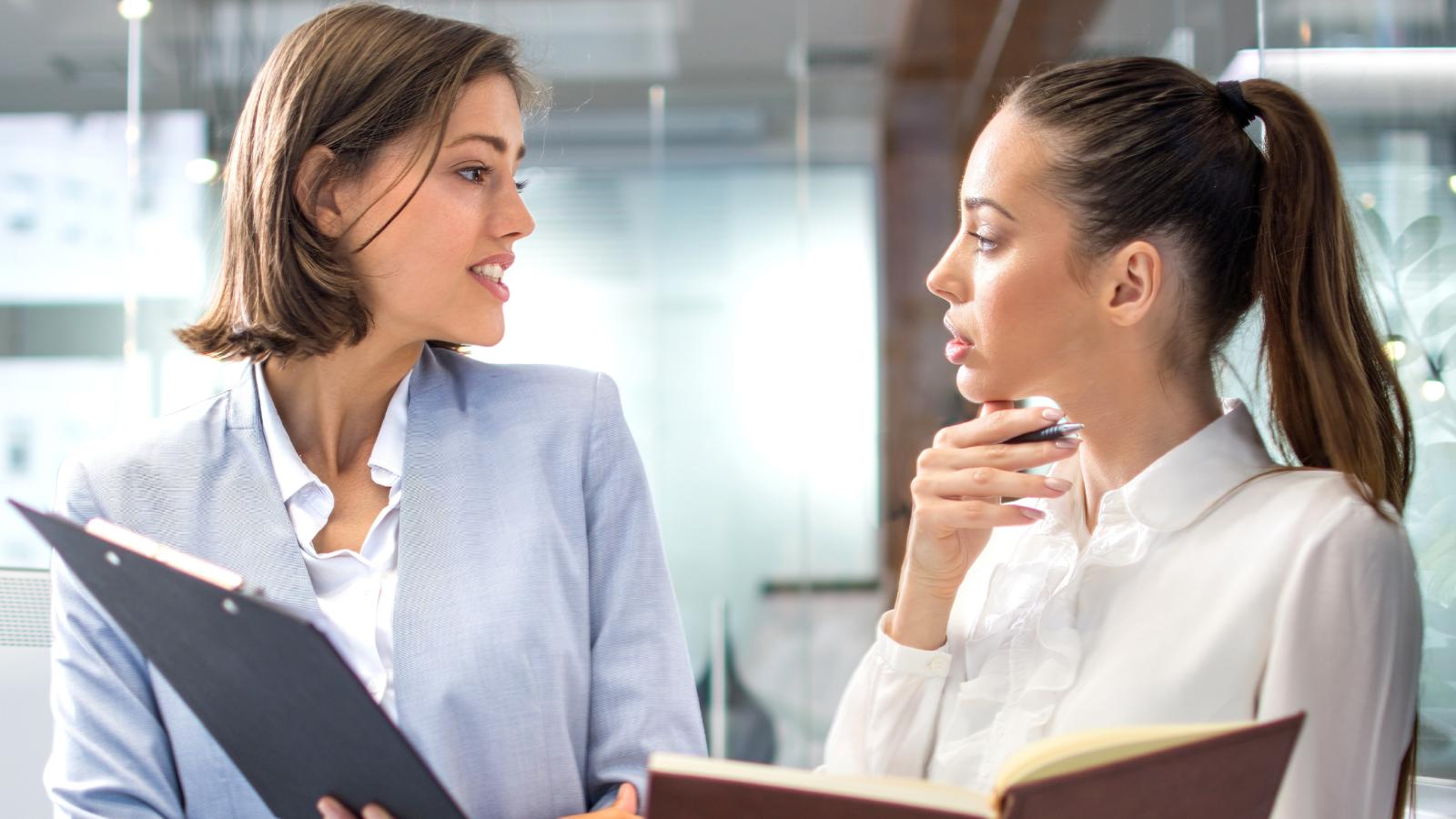 New Hire Thinks Her Manager Is Targeting Her After a Rough Start on the Job two women in an office