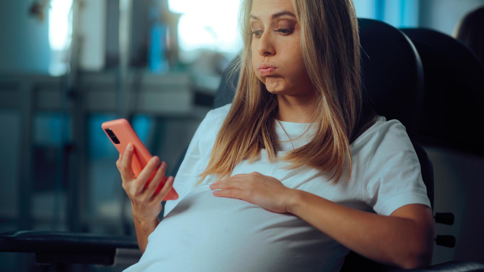 Her In Laws Demanded to Be Present for the Birth. The Pregnant Mom’s Firm No Has Sparked a Family War. pregnant woman looking at her phone