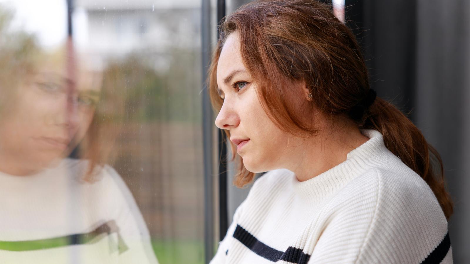 woman looking out a window