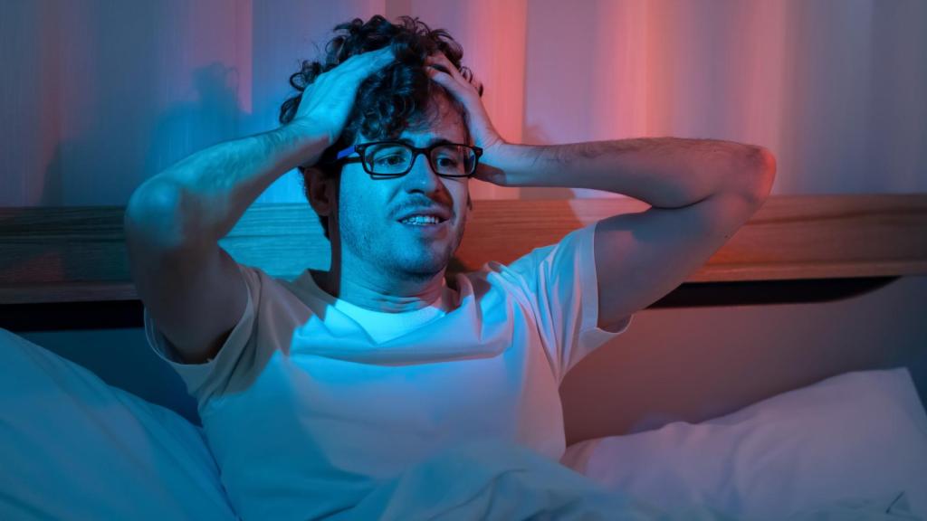 man in bed who can't sleep