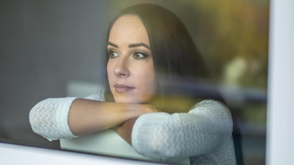 woman looking out a window