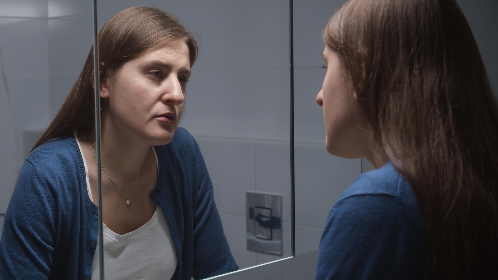 woman looking in a mirror