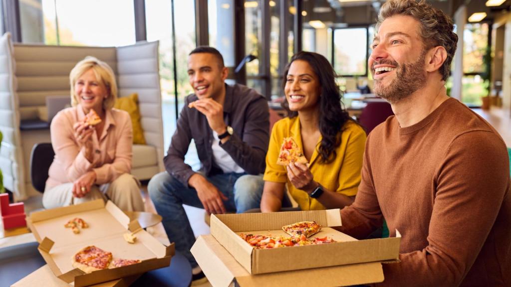workers eating pizza together