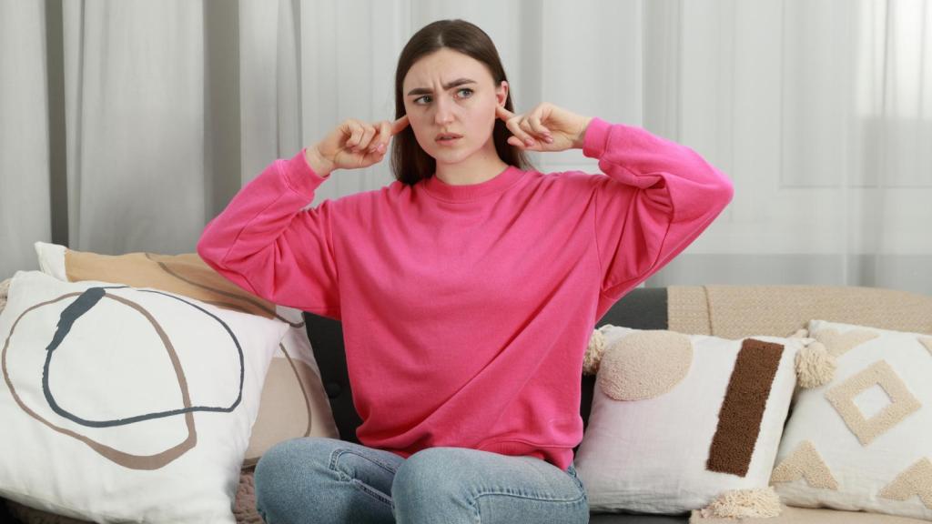 woman plugging her ears