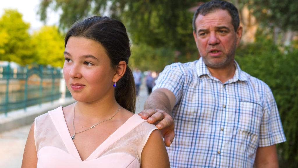 man talking to his daughter