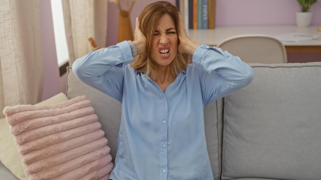 woman covering her ears