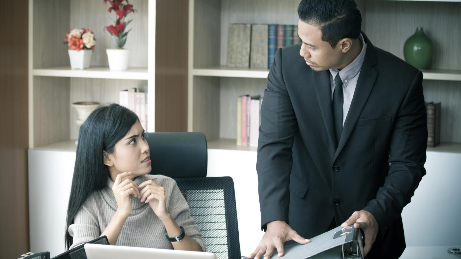 She Met and Married a Man From Her Workplace — Her Jealous Coworker Has Been Making Her Pay for It Ever Since man and woman in an office