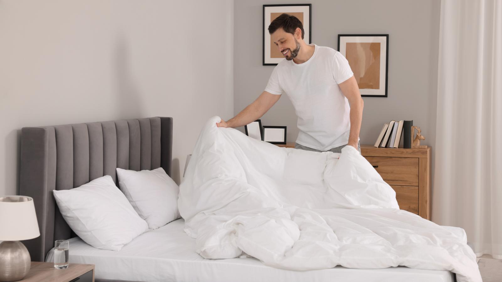 She Asked Her Husband to Help Out More Around the House. His Response Was Literally Making Half the Bed. man making a bed