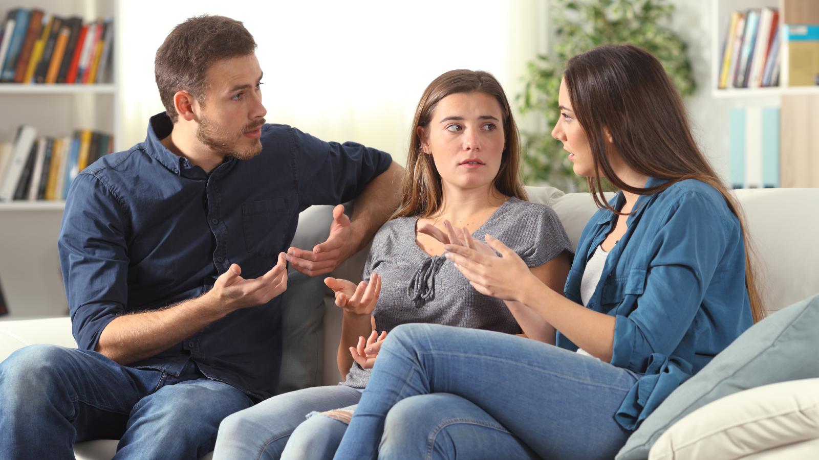 She Let Her Friends Live With Her For Free. Then They Handed Her a Bill For Household Essentials. three people having a talk