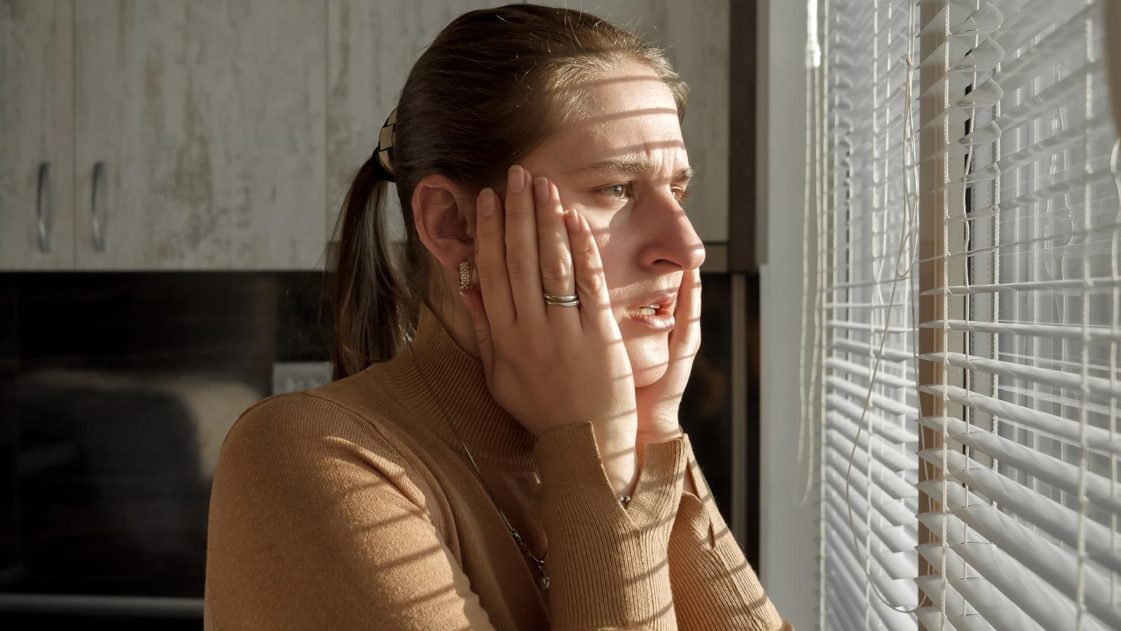 woman looking out a window