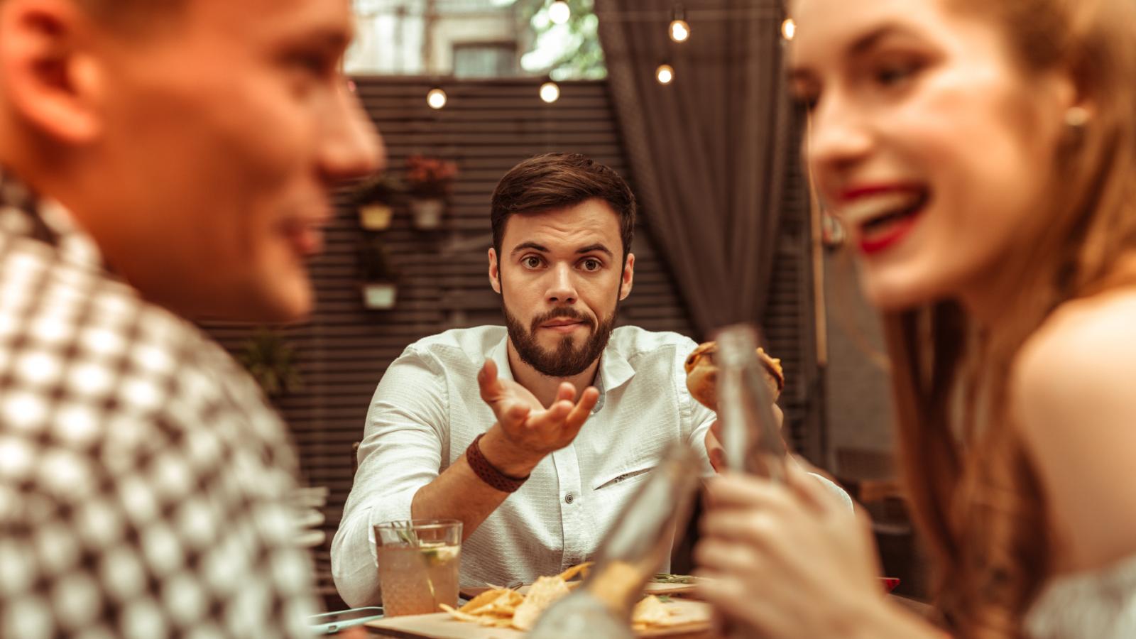 man at a restaurant with a couple