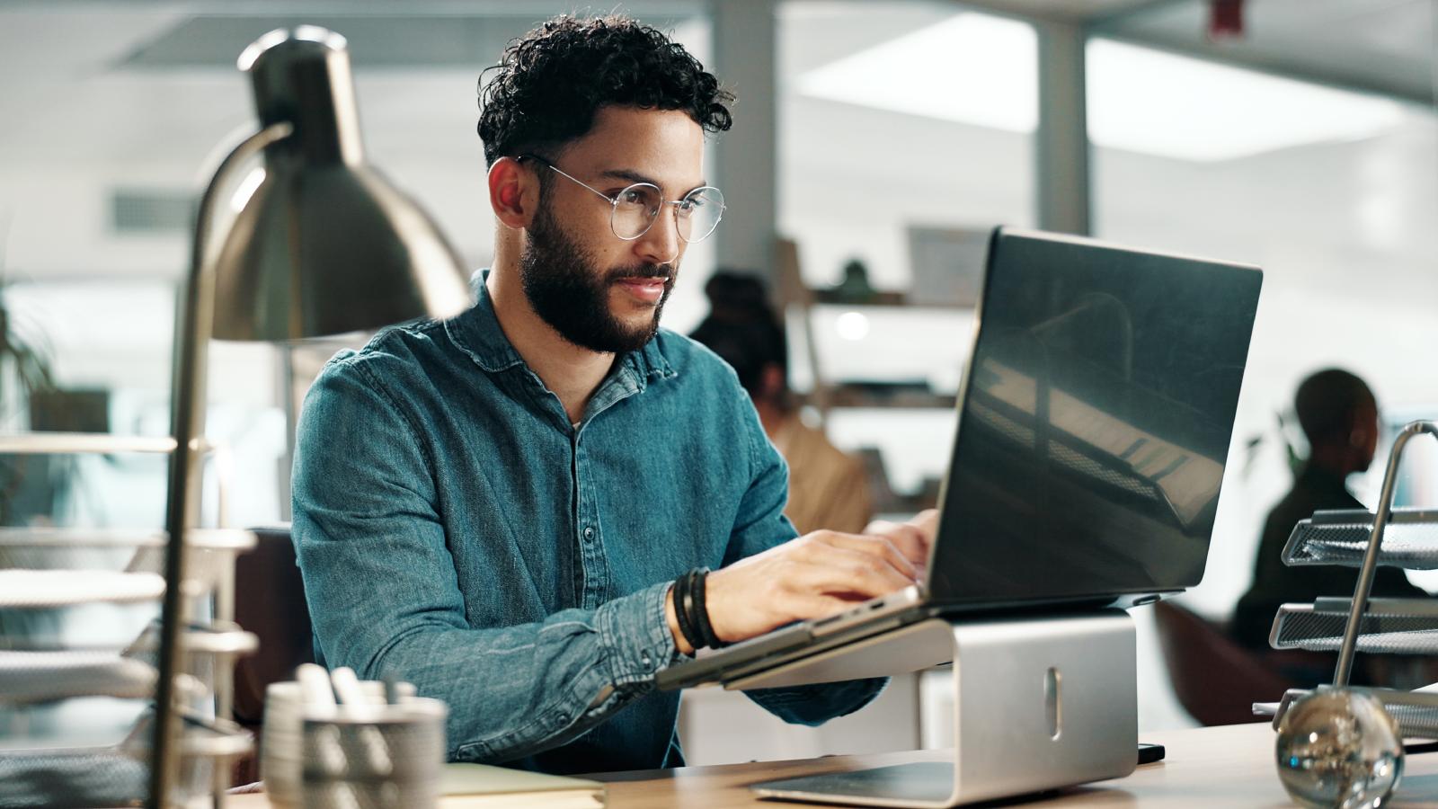 The Ghost in the System: How a Simple Code Choice Made Back in the Day Created a Multi Million Dollar Crisis for a Modern IT Team. man working on a computer