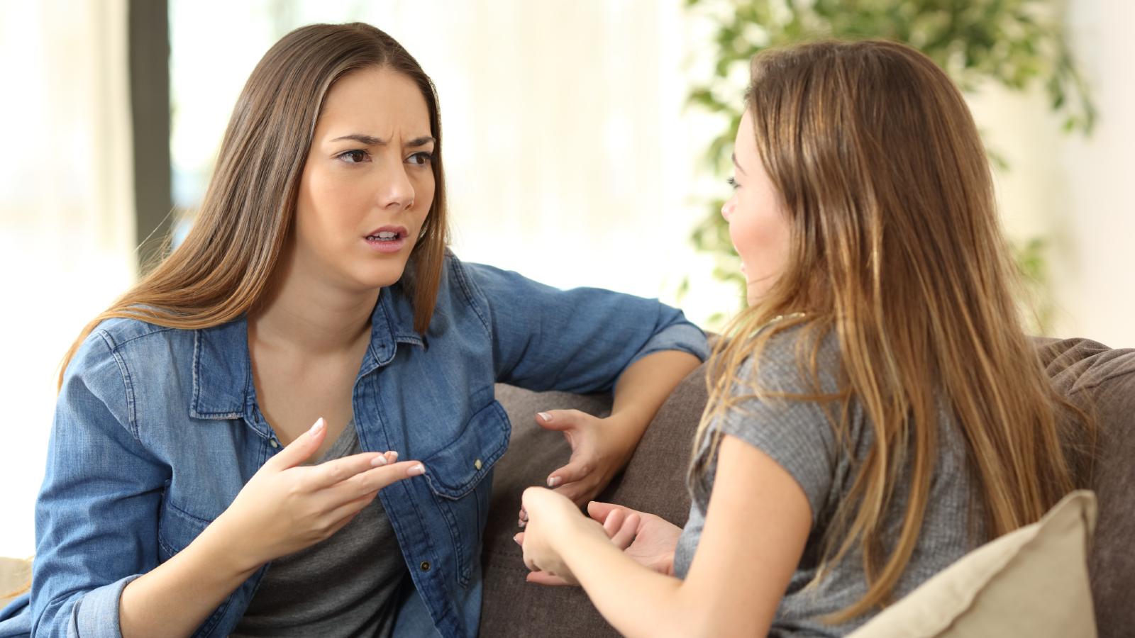 She Paid Her Share of the Utilities Every Month—Until She Found Out Her Roommate Never Sent the Money two women having a conversation
