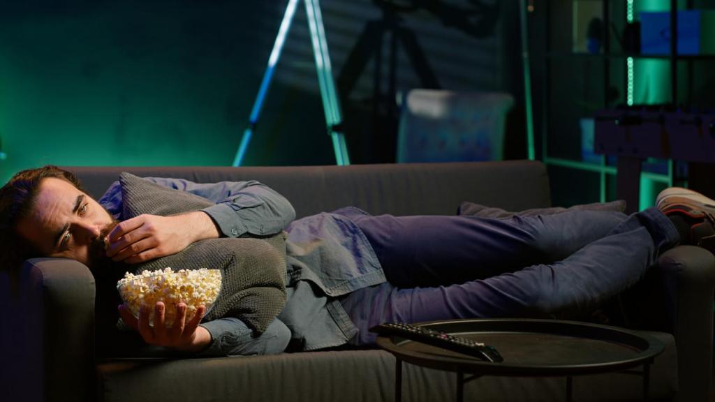 man laying on his couch