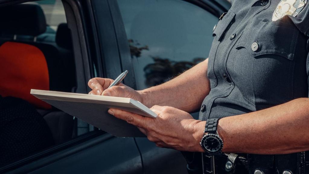 officer writing a speeding ticket