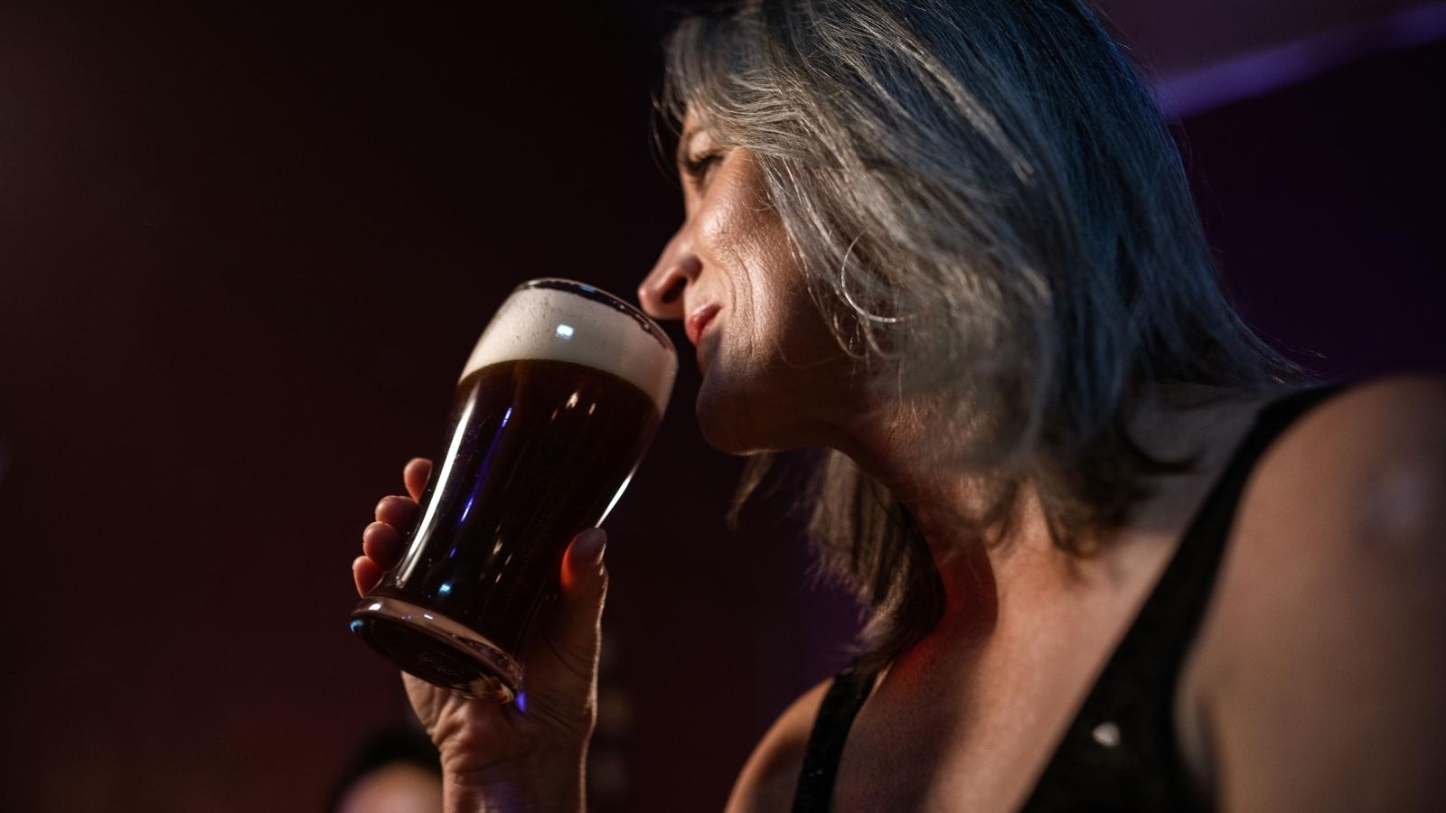 older woman drinking a beer