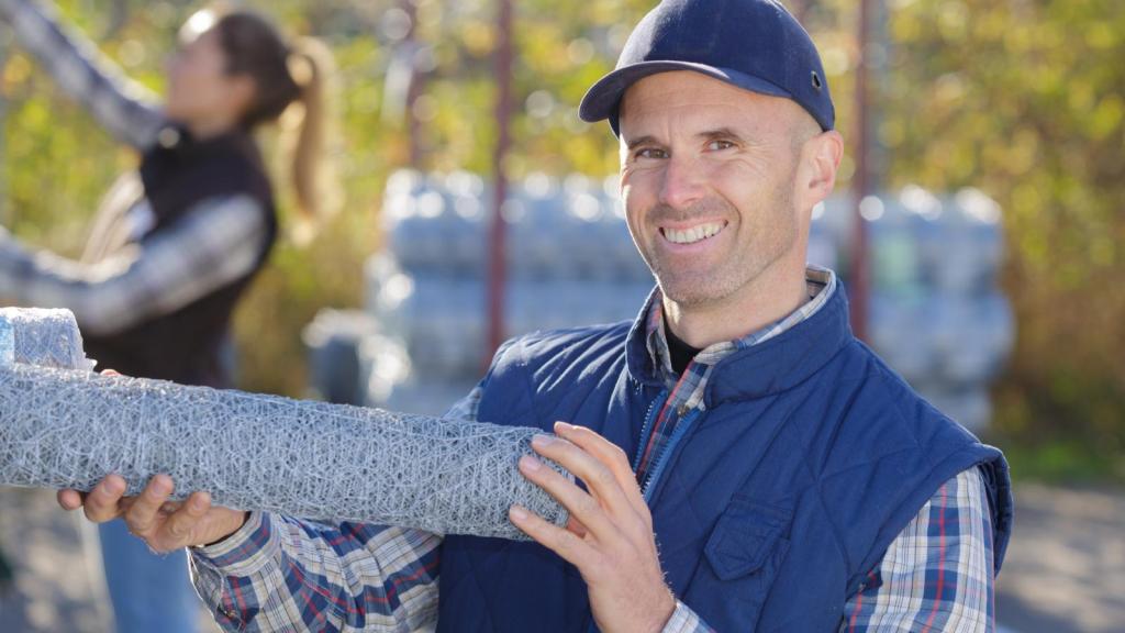 man holding chicken wire