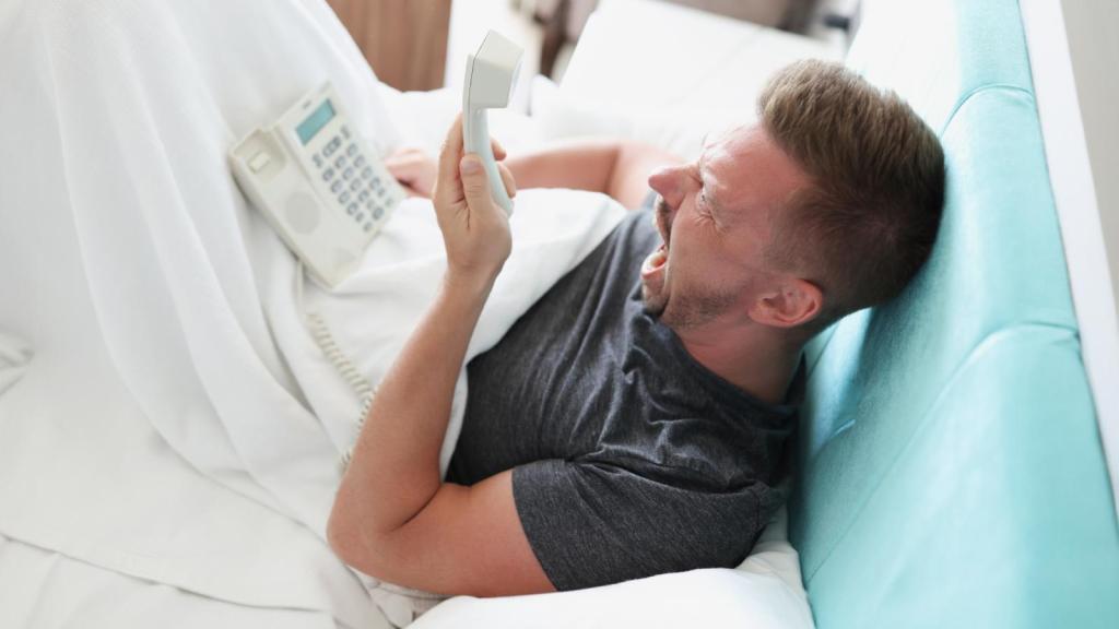 man in a bed with a phone