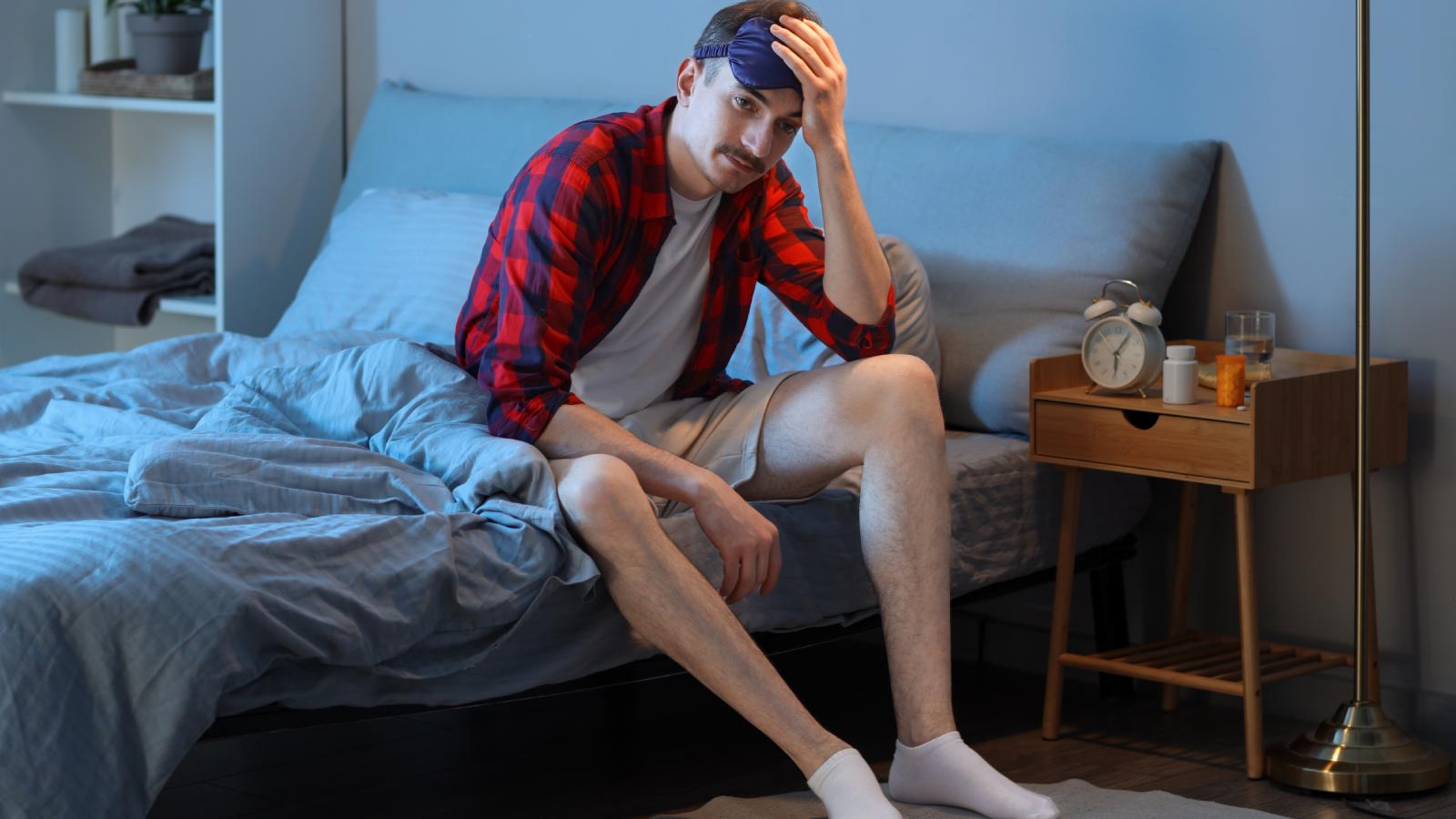 man sitting in bed