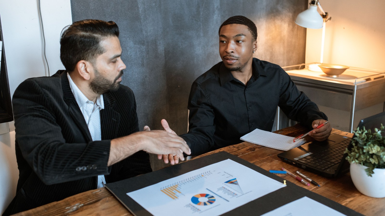 He Just Wanted a Few Days Off to Recharge. Instead, His Absence Triggered a Workplace Crisis That Doubled His Paycheck. two men about to shake hands in a meeting