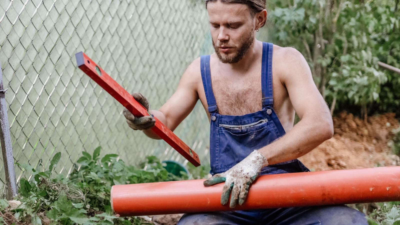 New Building Owner Faces Massive Expense After Discovering a Critical Utility Is Missing man holding a pipe