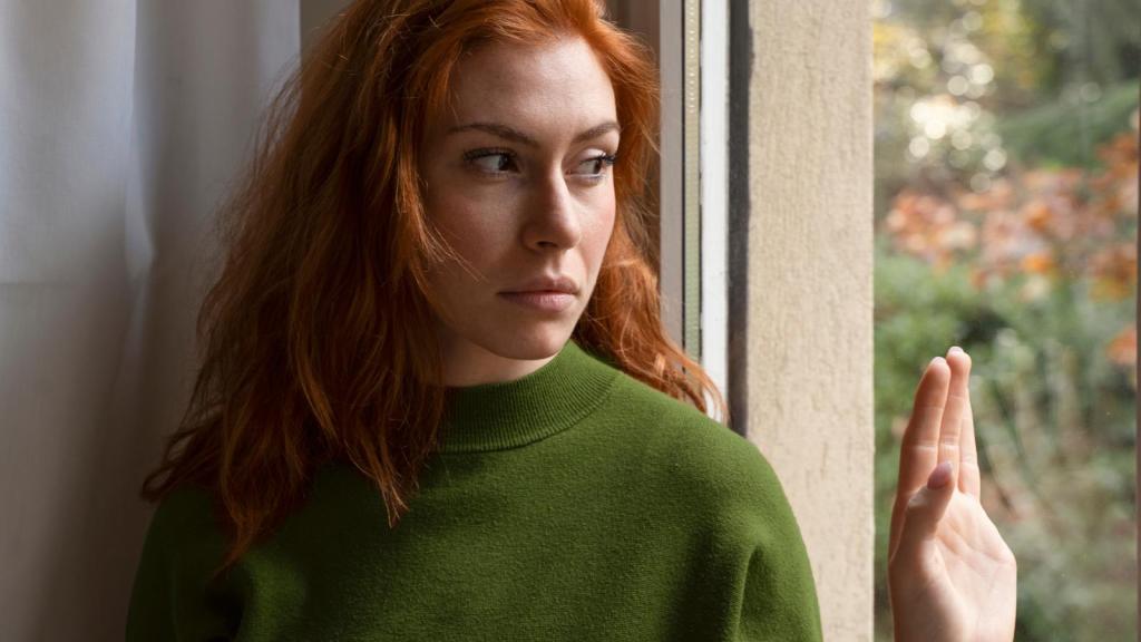 woman looking out a window