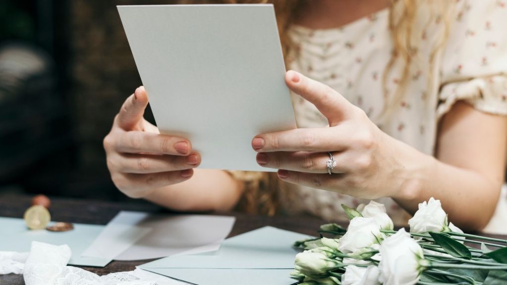 bride stuffing wedding invitations