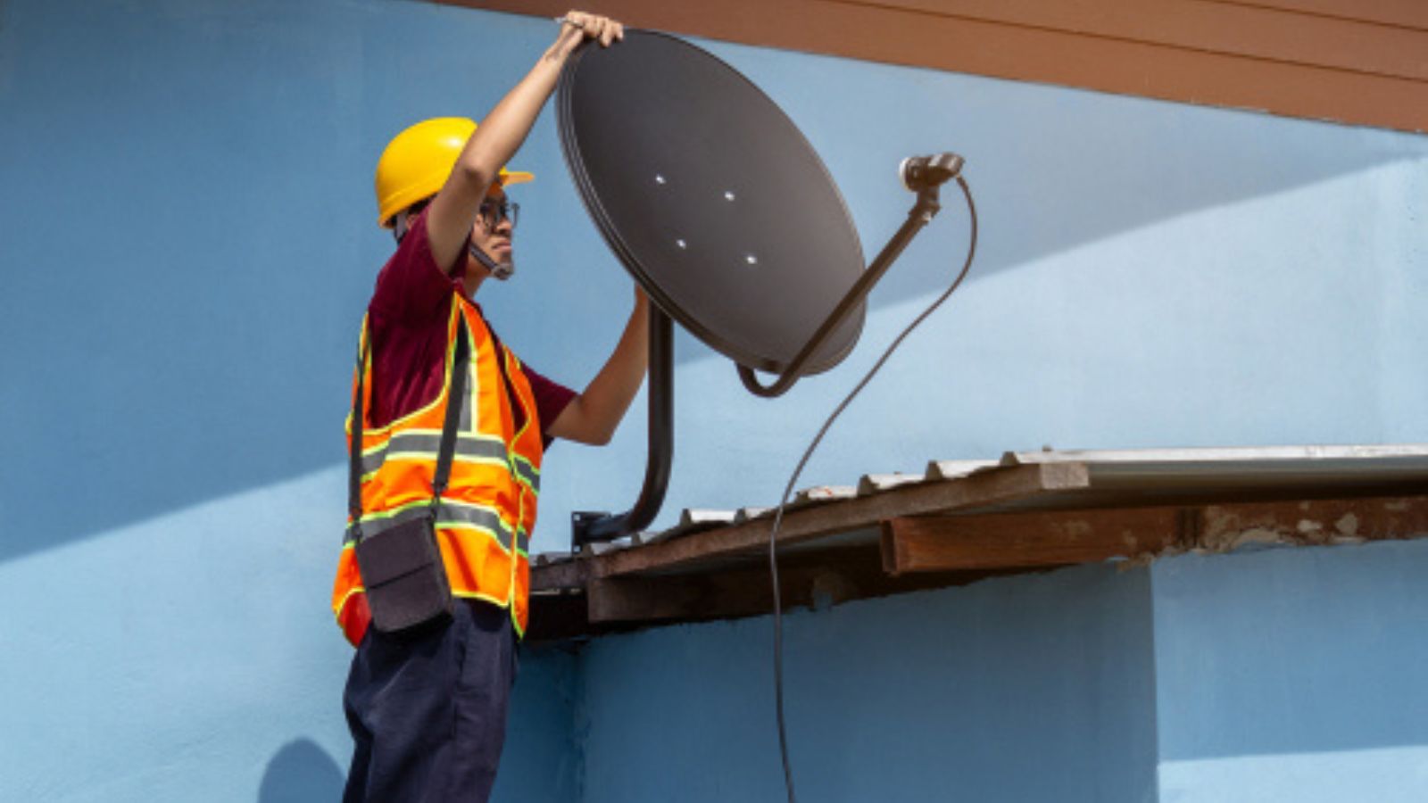 A Property Line Feud Takes A Strange Turn After One Neighbor Offers To “Fix” A New Problem Guy working on satellite dish