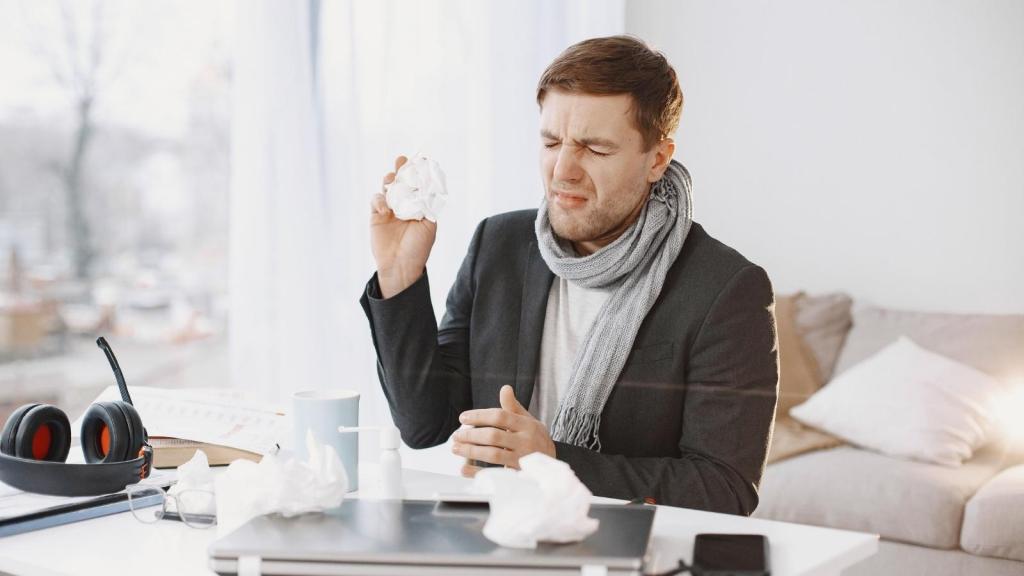 sick man working at his desk