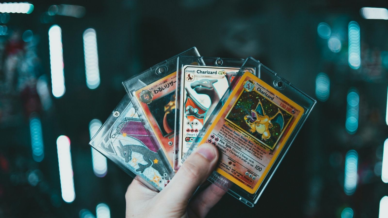 person holding pokemon cards