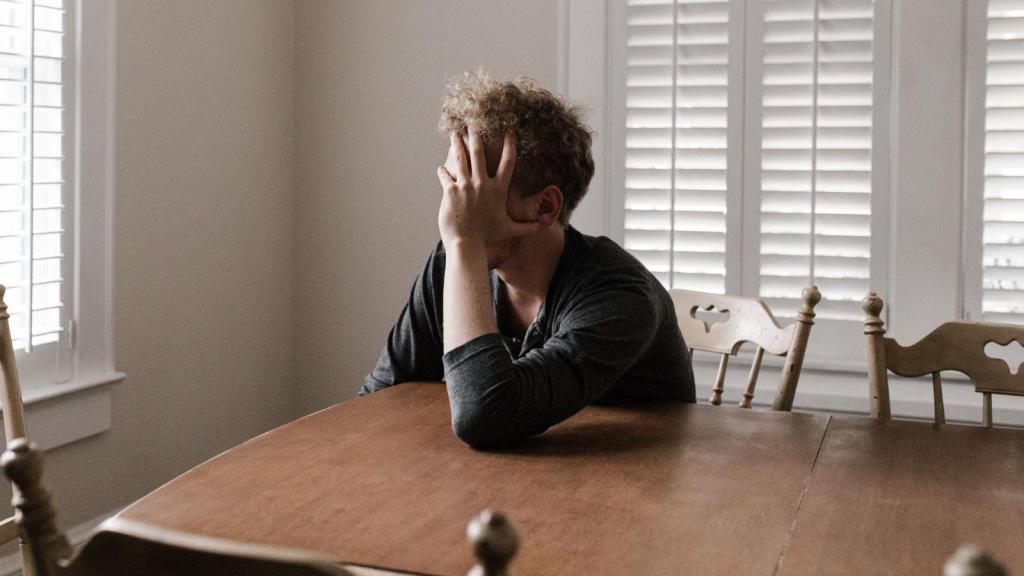 stressed man sitting at the dining room table