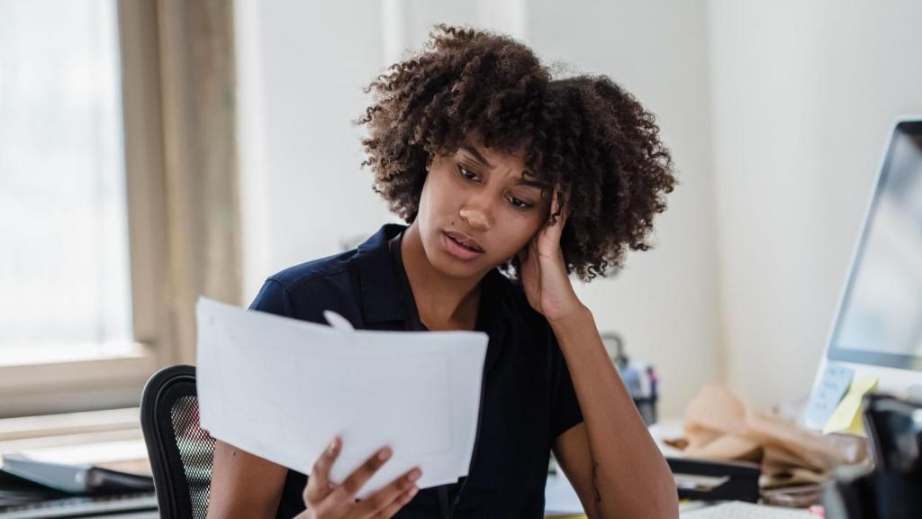 stressed woman looking at paper