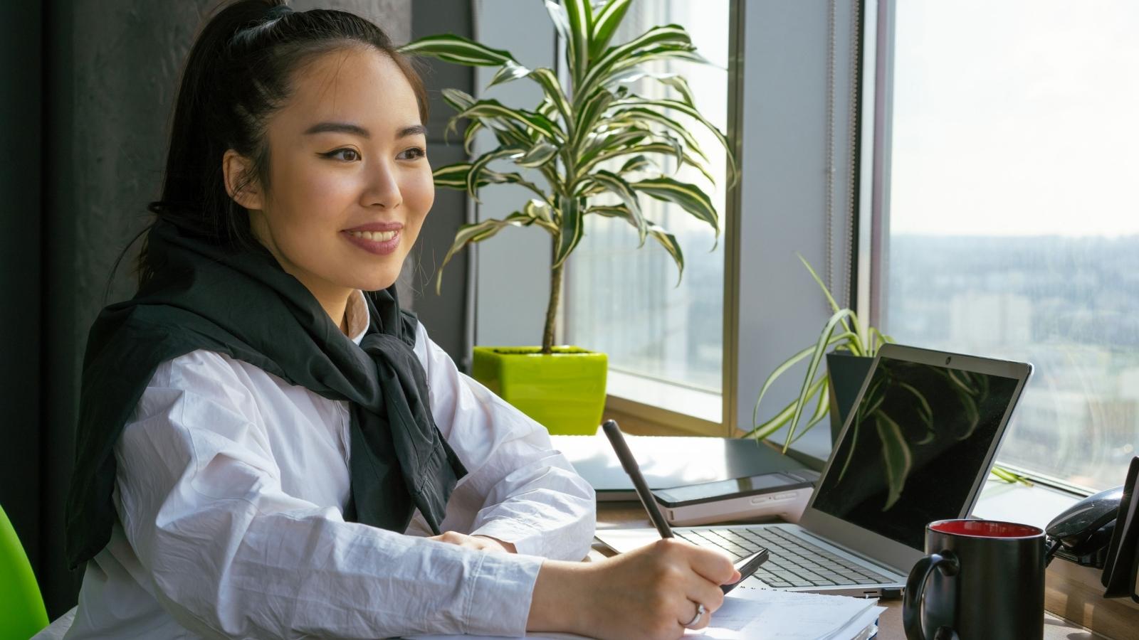 successful employee smiling at her desk