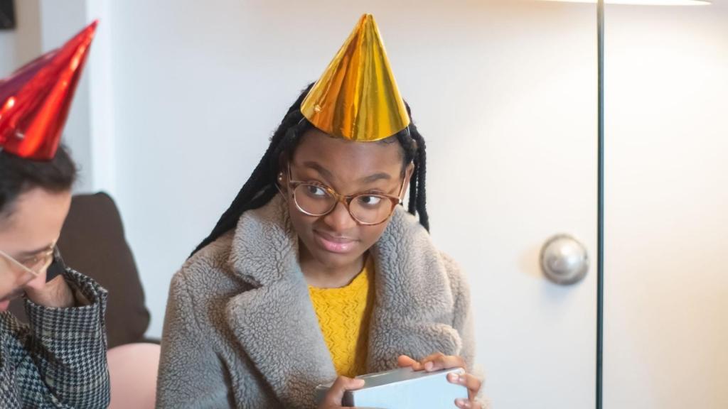 teenager in a yellow party hat