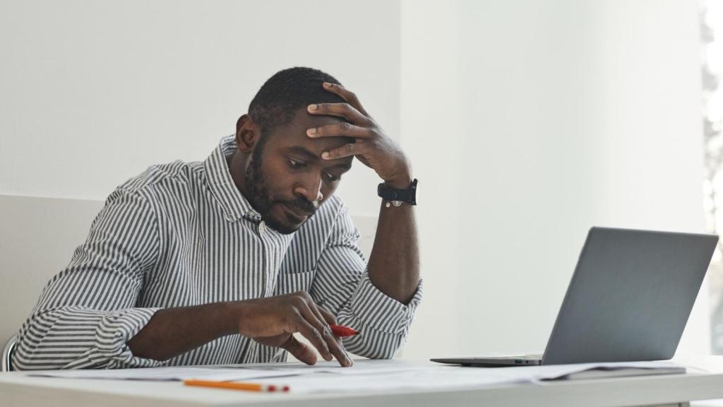 unhappy corporate worker at desk