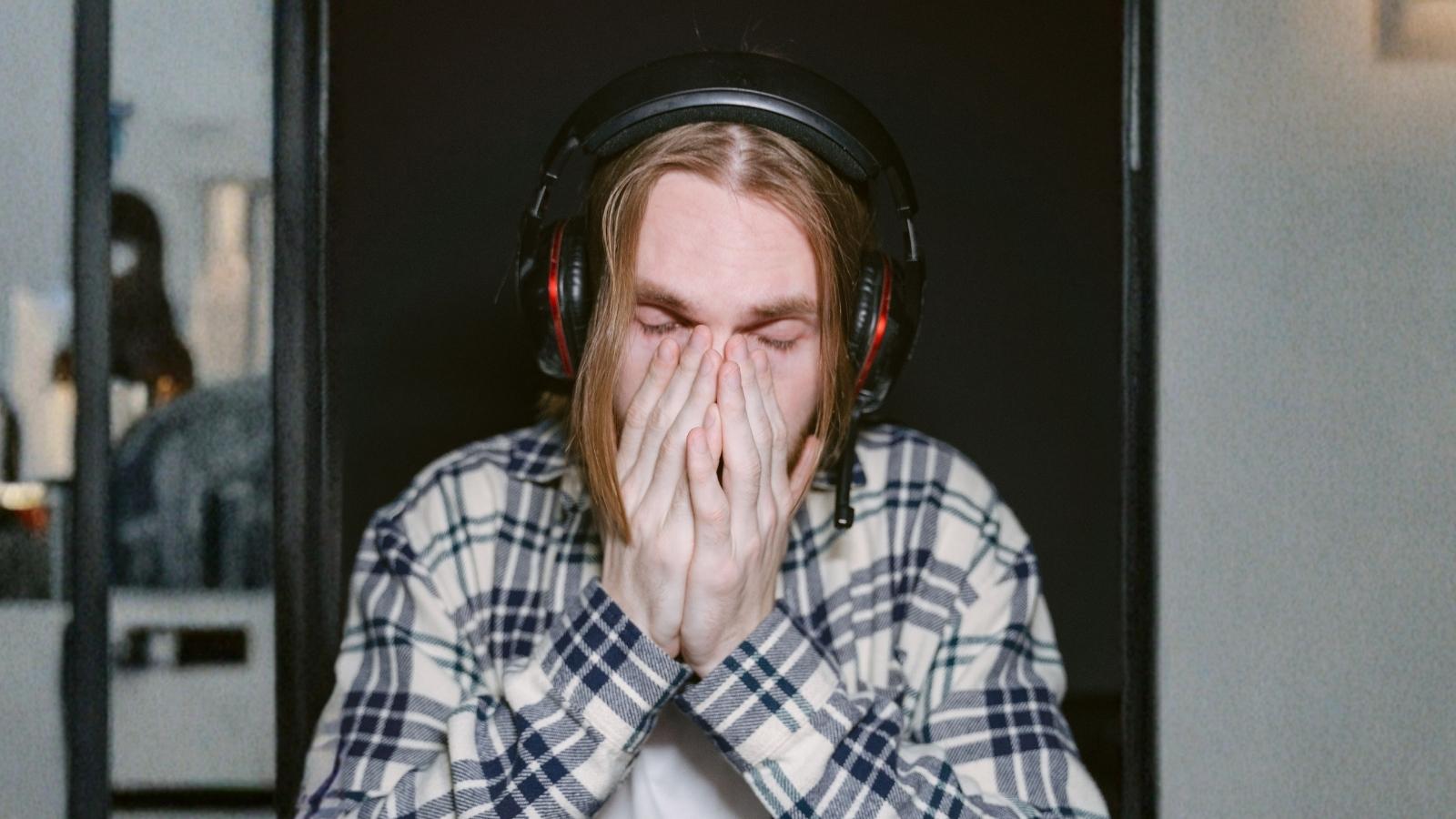He Turned His Home Into a Noise Cancelling Fortress to Block His Neighbors Subwoofer — Months of Early Morning Wake Up Calls Later Hes Out of Hope upset man wearing over ear headphones