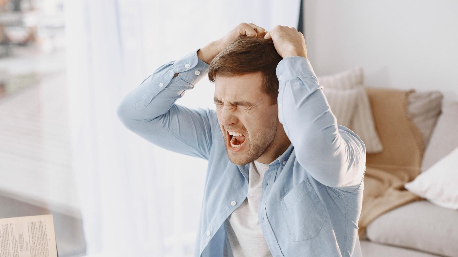 upset man with hands over head