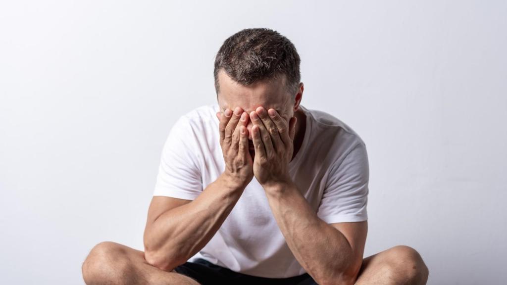 upset man with head in hands