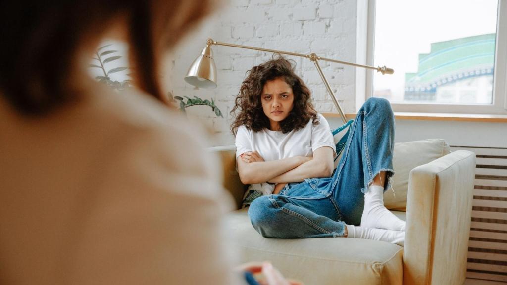 upset teenager sitting on the couch